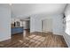 Bright open living space with hardwood floors seamlessly connecting the kitchen and a cozy seating area at 1195 Champion Dr, Cary, NC 27511