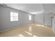 Bright living room with neutral walls, tile flooring, and natural light at 1195 Champion Dr, Cary, NC 27511