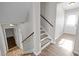 Stairway with wood-look flooring and neutral walls at 1195 Champion Dr, Cary, NC 27511