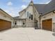 Wide driveway leading to two-car garages, showcasing ample parking and exterior lighting at 121 Anfield Rd, New Hill, NC 27562