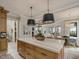 Open-concept kitchen features an island with seating that overlooks the dining and living areas at 121 Anfield Rd, New Hill, NC 27562