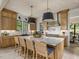 Gourmet kitchen with custom cabinetry, island with seating, and stainless steel appliances at 121 Anfield Rd, New Hill, NC 27562