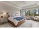 Bright main bedroom features a tray ceiling, ceiling fan, and large windows with natural light at 121 Anfield Rd, New Hill, NC 27562