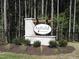 Community sign for Anfield Estates surrounded by verdant landscaping and set amongst mature trees at 121 Anfield Rd, New Hill, NC 27562