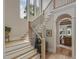 Elegant staircase with wooden treads, iron railing, and large windows for abundant natural light at 121 Anfield Rd, New Hill, NC 27562