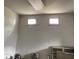 Close-up of interior wall, showcasing two square windows and an old air conditioning unit at 1403 S Roxboro Street, Durham, NC 27703