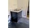 The interior features a utility sink with a black cabinet and countertop next to black floor at 1403 S Roxboro Street, Durham, NC 27703