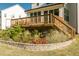 Beautiful backyard with a wooden deck and a stone-edged flower bed at 1475 Sierra Glen Cir, Apex, NC 27502