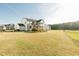 Sprawling backyard featuring a well-maintained lawn, wooden deck, and lush perimeter greenery at 1475 Sierra Glen Cir, Apex, NC 27502