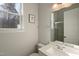 Bright bathroom features a modern vanity, large mirror, and a shower with glass doors at 1475 Sierra Glen Cir, Apex, NC 27502