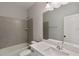 Bathroom featuring modern sink and vanity and a shower and tub combination with tile surround at 1475 Sierra Glen Cir, Apex, NC 27502