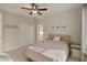 Bright bedroom with plush carpet, ceiling fan, and framed botanical prints adorning the walls at 1475 Sierra Glen Cir, Apex, NC 27502