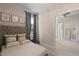 Comfortable bedroom featuring a large bed, neutral decor, and natural light from the window at 1475 Sierra Glen Cir, Apex, NC 27502
