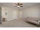 Well-lit bedroom showcasing a comfortable seating area and doorways to other rooms at 1475 Sierra Glen Cir, Apex, NC 27502