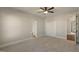 Neutral bedroom featuring soft carpet and multiple doorways leading to additional rooms at 1475 Sierra Glen Cir, Apex, NC 27502