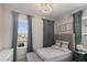 Serene bedroom features a tufted headboard, soft gray accents, and a window with neighborhood views at 1475 Sierra Glen Cir, Apex, NC 27502