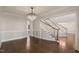 Sophisticated dining area includes hardwood floors, a decorative chandelier, and an open layout leading to the staircase and living spaces at 1475 Sierra Glen Cir, Apex, NC 27502