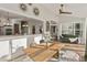 Sun-drenched dining room boasts an open layout, seamlessly connecting to the kitchen and living area, complete with a stylish table setting at 1475 Sierra Glen Cir, Apex, NC 27502