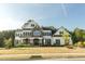 Beautiful two-story home featuring a manicured lawn, stone accents, dark shutters, and ample curb appeal at 1475 Sierra Glen Cir, Apex, NC 27502