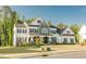 Gorgeous two-story home featuring a lush lawn, black shutters, stone accents, and covered entryway at 1475 Sierra Glen Cir, Apex, NC 27502