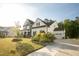 Charming two-story home with stone accents, lush landscaping, and an attached garage at 1475 Sierra Glen Cir, Apex, NC 27502