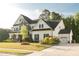 Beautiful two-story home with stone accents, manicured lawn, and attached two car garage at 1475 Sierra Glen Cir, Apex, NC 27502