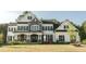 Charming two-story home with stone accents, black shutters, manicured lawn, and a welcoming front porch at 1475 Sierra Glen Cir, Apex, NC 27502