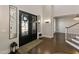 Elegant foyer features dark wood floors, a grand entrance with black double doors, and a view of the staircase and formal dining room at 1475 Sierra Glen Cir, Apex, NC 27502
