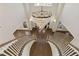 Elegant foyer featuring dual staircases, a grand chandelier, and hardwood floors at 1475 Sierra Glen Cir, Apex, NC 27502