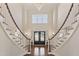 Stunning foyer featuring dual staircases, a modern chandelier, and dark hardwood floors at 1475 Sierra Glen Cir, Apex, NC 27502