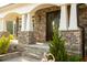 Charming front porch with stone accents, white columns, and decorative details, creating an inviting entry at 1475 Sierra Glen Cir, Apex, NC 27502