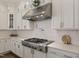 Kitchen features a stainless steel range hood and white subway tile backsplash at 1475 Sierra Glen Cir, Apex, NC 27502