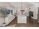 Gourmet kitchen with white cabinetry, stainless steel appliances, and a large center island perfect for entertaining at 1475 Sierra Glen Cir, Apex, NC 27502