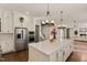 Bright kitchen features a large island, stainless steel appliances, and hardwood floors at 1475 Sierra Glen Cir, Apex, NC 27502