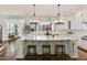 Bright kitchen features a large island with bar seating and backyard views at 1475 Sierra Glen Cir, Apex, NC 27502