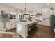 Spacious white kitchen boasts an island with bar seating and stainless steel appliances at 1475 Sierra Glen Cir, Apex, NC 27502