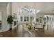 Bright living room featuring soaring ceilings, a fireplace, large windows, and hardwood floors at 1475 Sierra Glen Cir, Apex, NC 27502