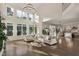 Bright living room with soaring ceilings, large windows, and hardwood floors that create a welcoming atmosphere at 1475 Sierra Glen Cir, Apex, NC 27502