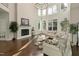 Open-concept living room features hardwood floors, fireplace, and abundant natural light through large windows at 1475 Sierra Glen Cir, Apex, NC 27502