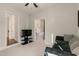 Cozy living room area with soft carpet, comfortable seating, and doorway views of other rooms at 1475 Sierra Glen Cir, Apex, NC 27502