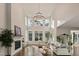 Bright living room featuring tall ceilings, a fireplace, large windows, and hardwood floors at 1475 Sierra Glen Cir, Apex, NC 27502