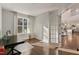Cozy home office with hardwood floors, a large window with natural light, and an inviting workspace adjacent to the kitchen at 1475 Sierra Glen Cir, Apex, NC 27502