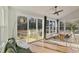 Sunroom features large windows, deck access, and cozy seating area for relaxing at 1475 Sierra Glen Cir, Apex, NC 27502