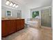 This bathroom has a soaking tub, and sinks, and tile floors at 148 Daneborg Rd, Durham, NC 27703