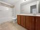Bathroom featuring tile floors, a bathtub with shower, and a vanity with dark wood cabinets at 148 Daneborg Rd, Durham, NC 27703