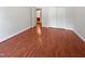 Bedroom features hardwood floors, white trim, window, and sliding door closet at 148 Daneborg Rd, Durham, NC 27703