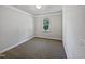 This bedroom has gray carpet and a single window providing natural light at 148 Daneborg Rd, Durham, NC 27703