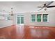 Spacious living room with kitchen view, multiple windows and cherry wood flooring at 148 Daneborg Rd, Durham, NC 27703