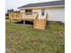The wooden deck of this home features new construction and a staircase to the yard at 1602 Fairground Rd, Dunn, NC 28334