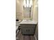This bathroom features neutral paint colors, wood-look floors, and a single sink vanity at 1602 Fairground Rd, Dunn, NC 28334